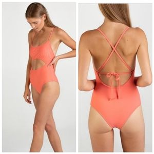 Gymshark one piece swimsuit with adjustable straps on the back.  bare abdomen.